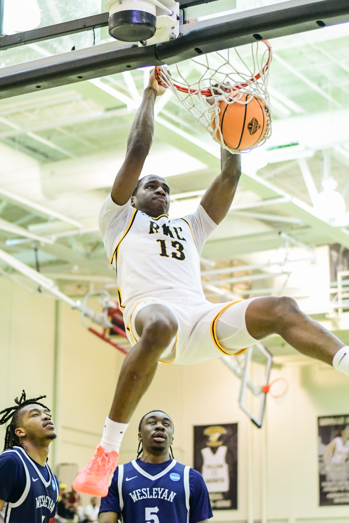 Randolph–Macon #13 throwing down a dunk during a home game