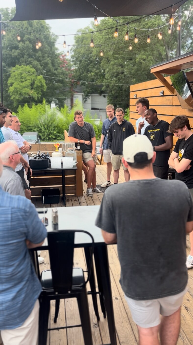 Alumni and student-athletes gathered on the deck at Sports Page Grille