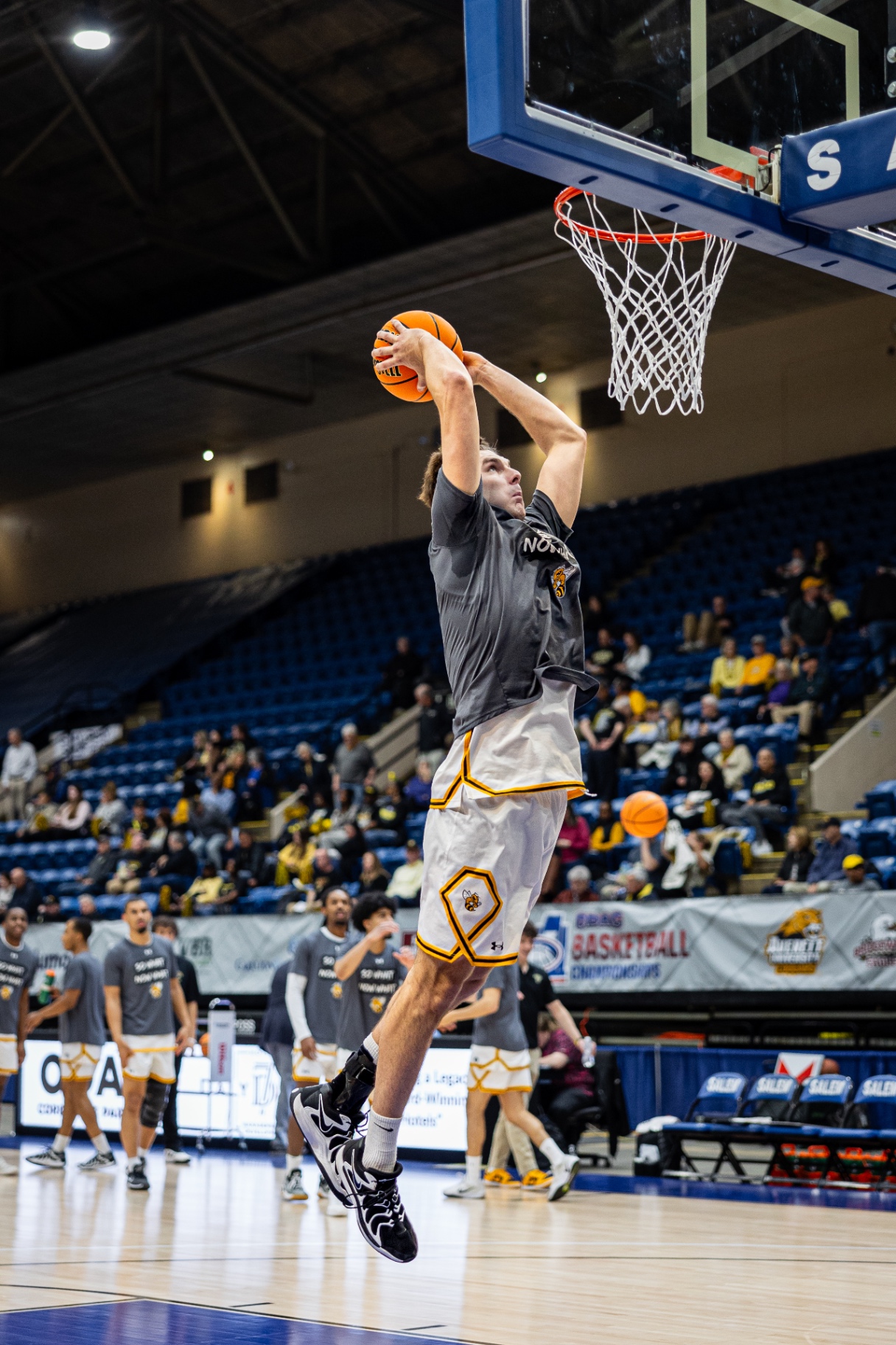 Randolph–Macon player rising for a slam dunk at the ODAC Finals